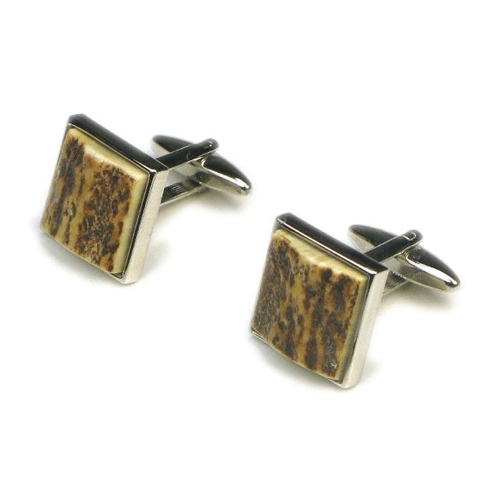 A pair of square cufflinks with stag antler inlays, mounted on a white background.