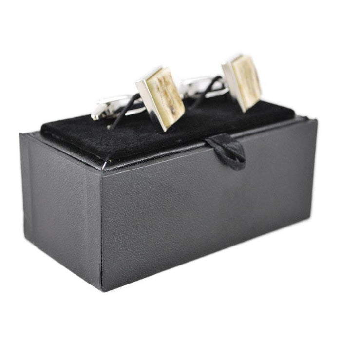 A pair of square cufflinks with stag antler inlays, mounted on a white background.
