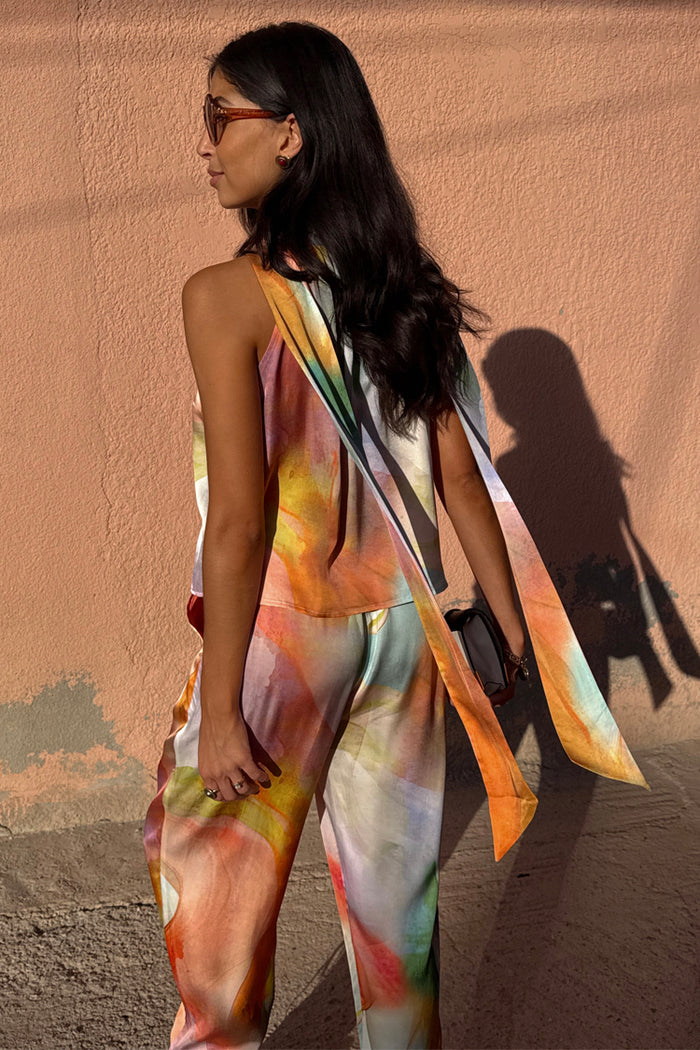 Abstract Lily Top featuring a vibrant multicoloured print and long tie neck fastenings draped over the shoulders.