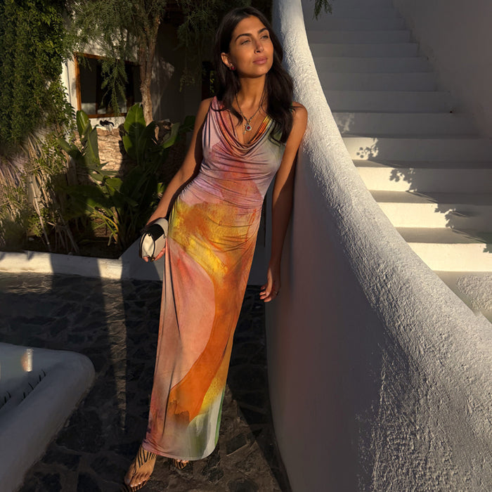 Abstract Malika Dress in stretch jersey with a draped neckline and multicoloured print, leaning against a white wall.