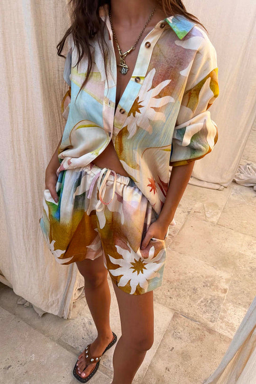 Abstract Soleil Ellie Shorts in a multicoloured sun print with a drawstring waist, styled as a co-ord set.