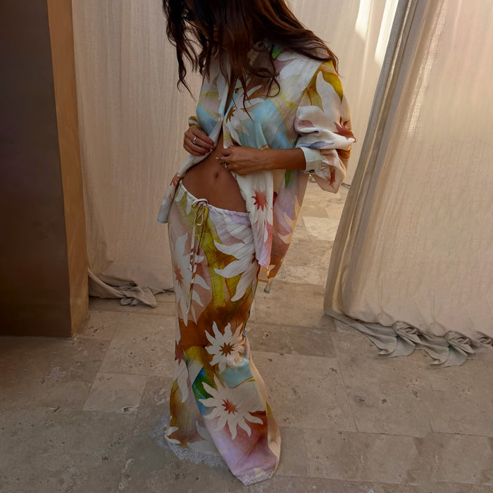 Abstract Soleil Mabel Skirt with sun motifs, a drawstring waist and lace hem detailing, paired with a matching shirt.