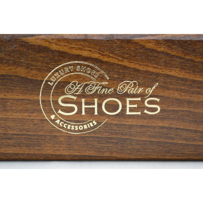 A wooden shoe shine brush with horsehair bristles, one with the brand 'AFPOS' visible on the top.