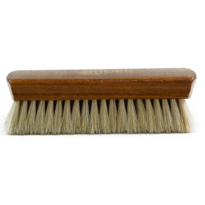 A wooden shoe shine brush with horsehair bristles, one with the brand 'AFPOS' visible on the top.