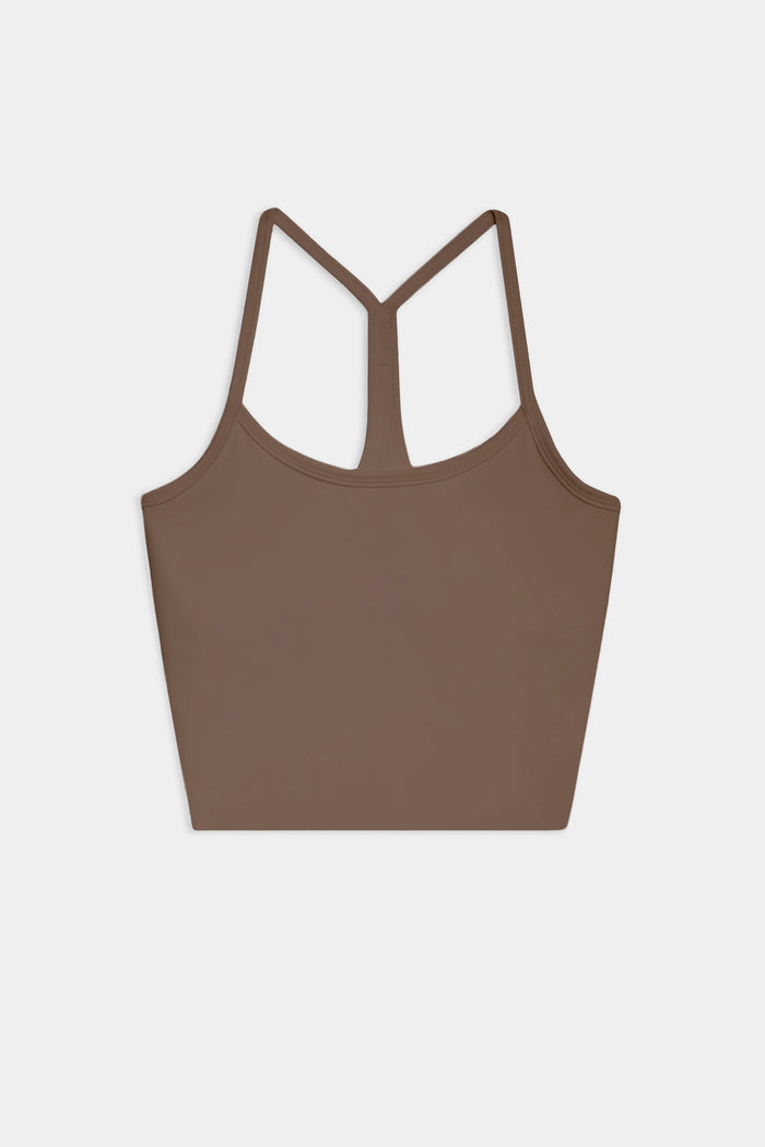 The SPLITS59 Airweight Crop - Lentil is a brown racerback tank with thin straps, ideal for hot yoga. Shown laid flat on a white background.