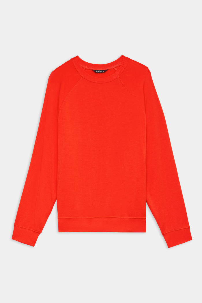 The SPLITS59 Andie Oversized Fleece Sweatshirt in Lotus Red, a long-sleeved crewneck pullover made in Los Angeles, is shown laid flat on a white background.