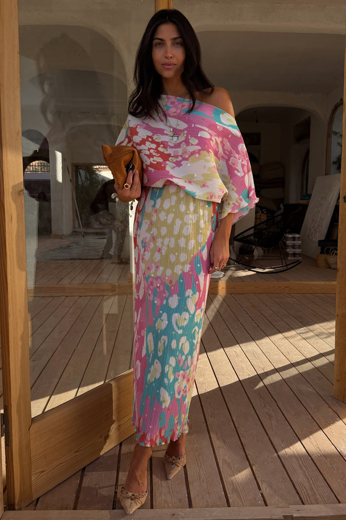 Multicoloured Animal Print Tilly Dress with silver metallic flecks and a voluminous top, styled with a brown clutch.