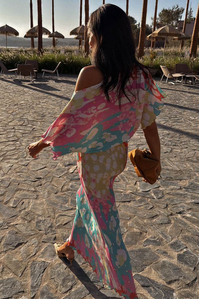 Multicoloured Animal Print Tilly Dress with silver metallic flecks and a pleated texture in a vacation setting.