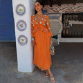 Apricot Embellished Ines Dress with mirror details, V-neckline and peplum waist in a sunny vacation setting.
