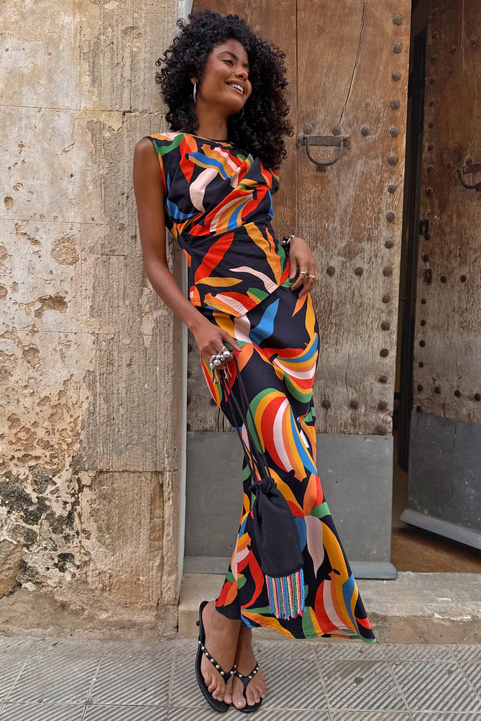 Banana A-Symmetric Top and matching skirt with vibrant multicoloured banana motifs on a black jersey base.