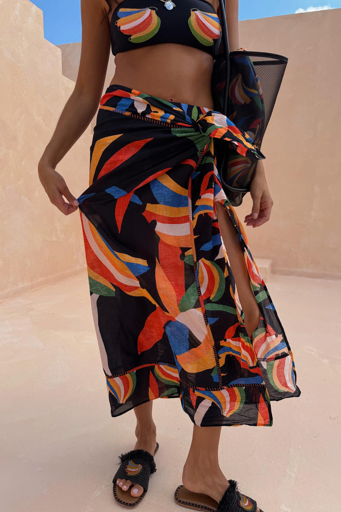 Banana Sarong with a multi-colour print on a black base, blanket stitching and wrap tie for multi-wear styling.