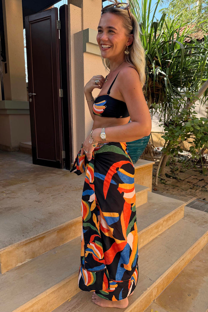 Banana Sarong with a multi-colour banana print and wrap tie, styled as a multi-wear cover-up on a 5ft5” model.