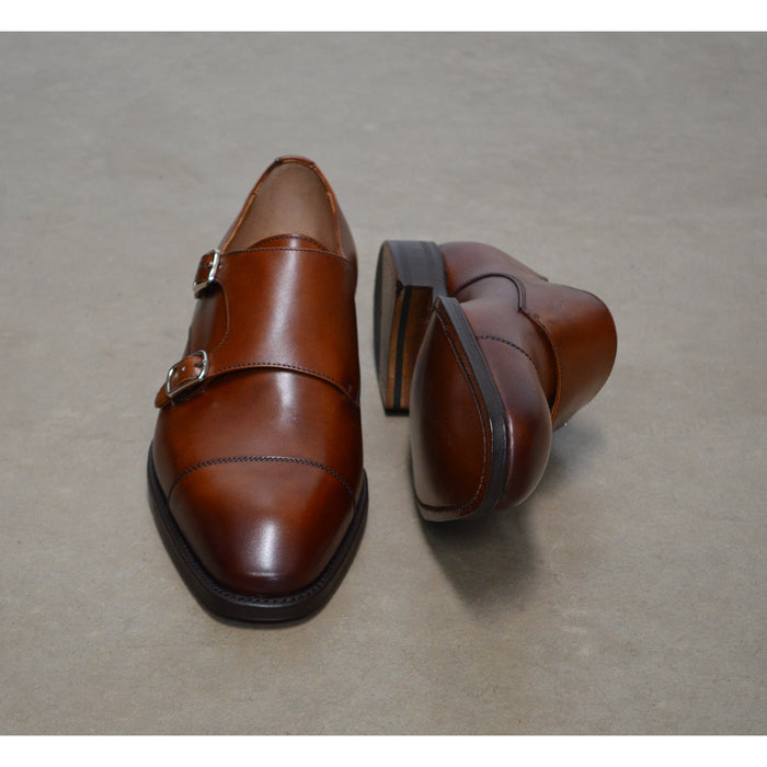 A brown Berwick 1707 double monk shoe with double buckle monk strap on a white background.
