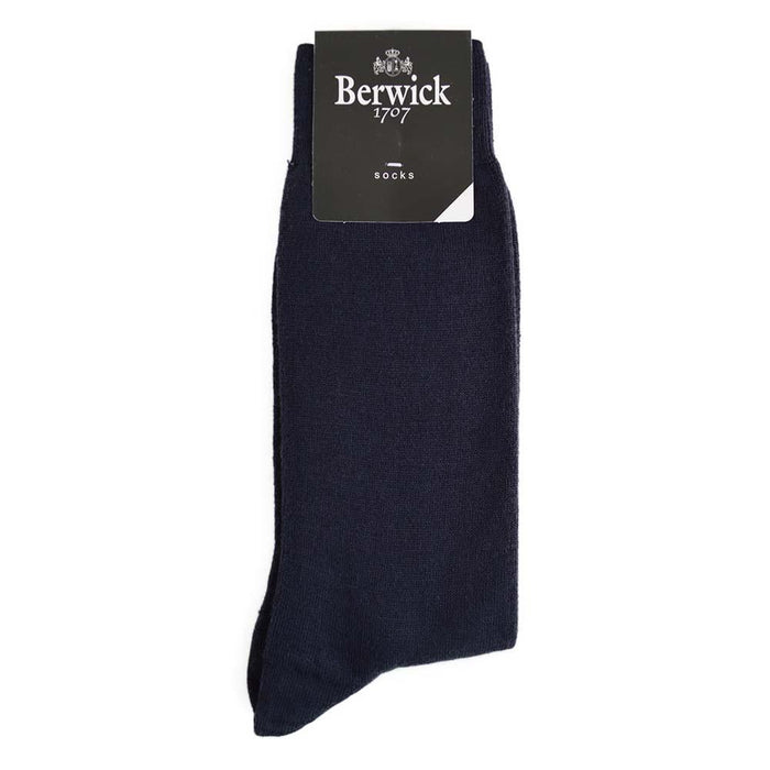 A pair of navy plain knit socks with the Berwick 1707 brand tag visible.
