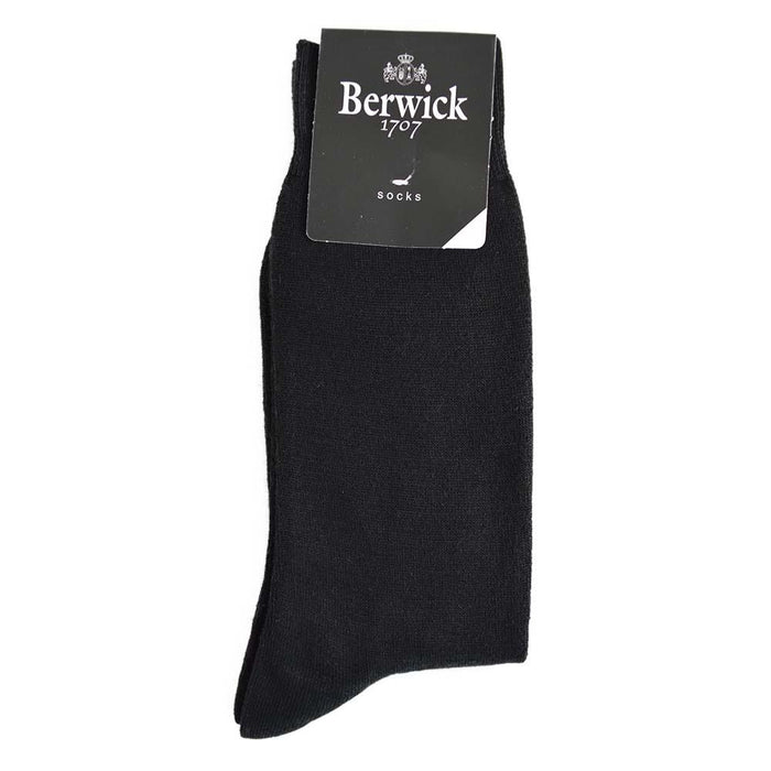 A pair of black plain knit socks with the Berwick 1707 brand tag visible.