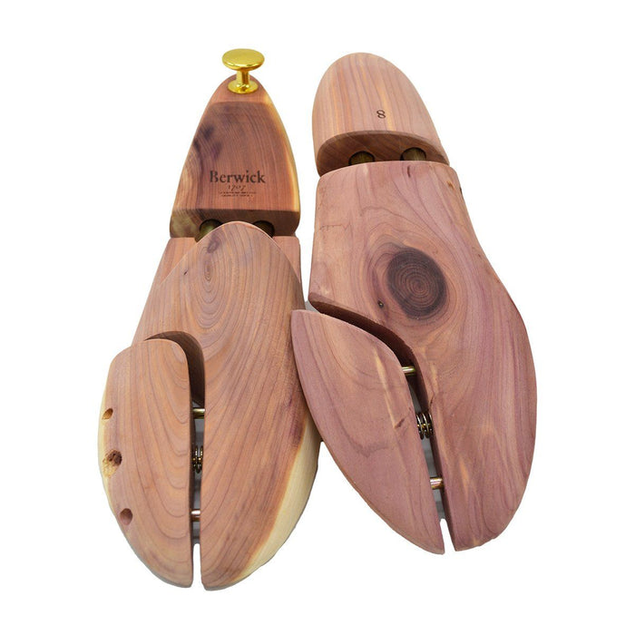 A Berwick 1707 cedar wood shoe tree with brass fitments, displayed in an open position showing the interior structure.
