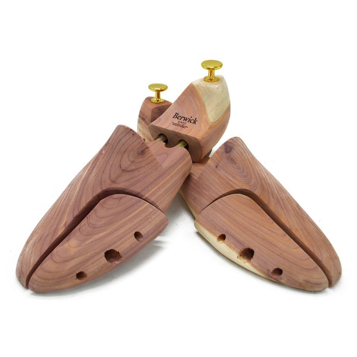 A Berwick 1707 cedar wood shoe tree with brass fitments, displayed in an open position showing the interior structure.