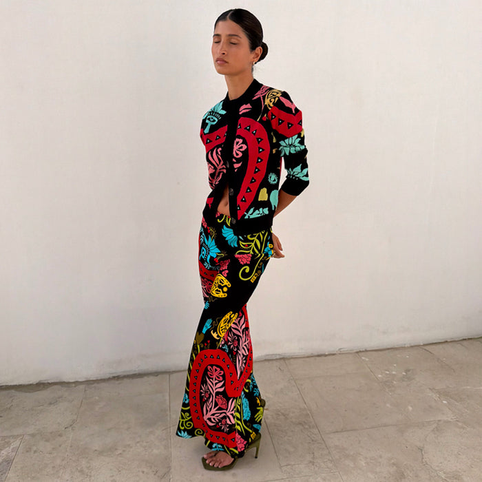 Black Amara Dorris Skirt featuring colourful hand-painted motifs, styled with a matching cardigan.