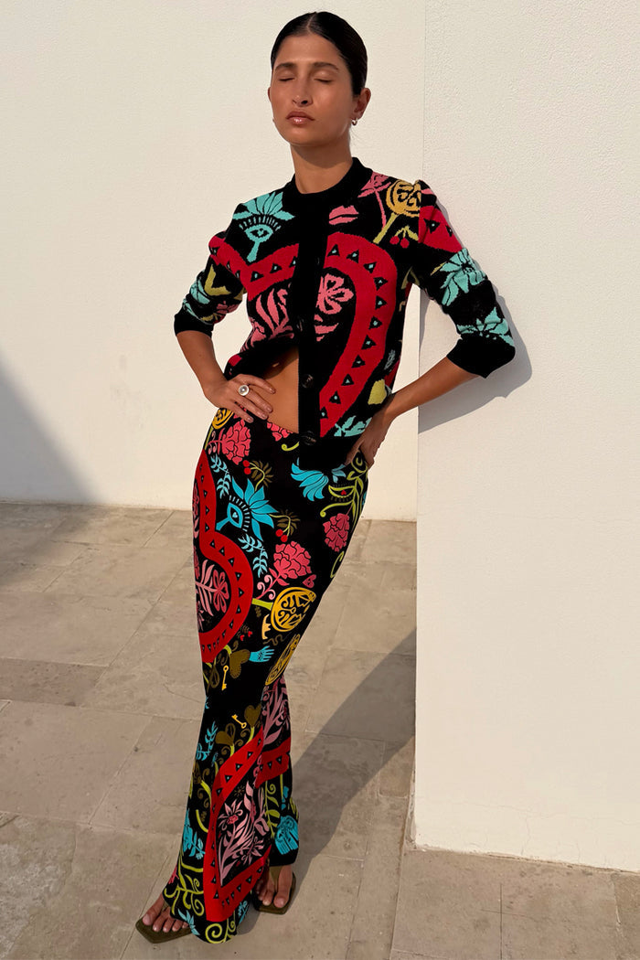 Black Amara Dorris Skirt with colourful hand-painted heart and eye motifs, styled with a matching cardigan.