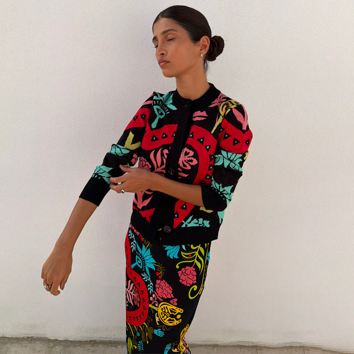 Black Amara Hollie Cardigan in a slim fit knit with hand-painted eye and heart motifs on a model.