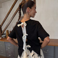 Black Bow Back T-Shirt featuring cream ribbon fastenings on the open back and a relaxed cotton silhouette.