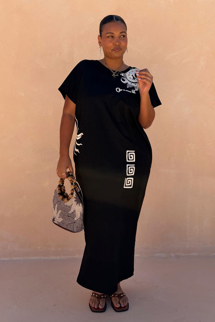 Black Dolce Vita T-Shirt Dress with hand-painted sun motifs and Greek graphics, styled as a multi-wear cotton maxi.