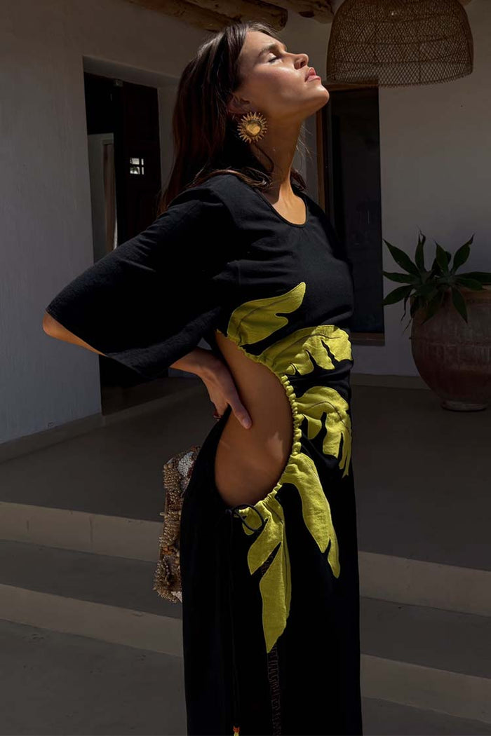Black Palm Riviera Dress with lime palm motifs and adjustable cut-out waist detail, ideal for a summer vacation.
