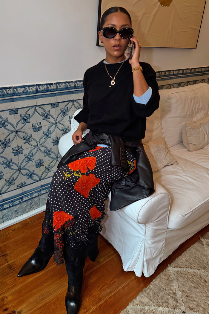 Black Poppy Midi Maeva Skirt with red poppy and polka dot print and lace trim, styled with a black jumper and leather jacket.