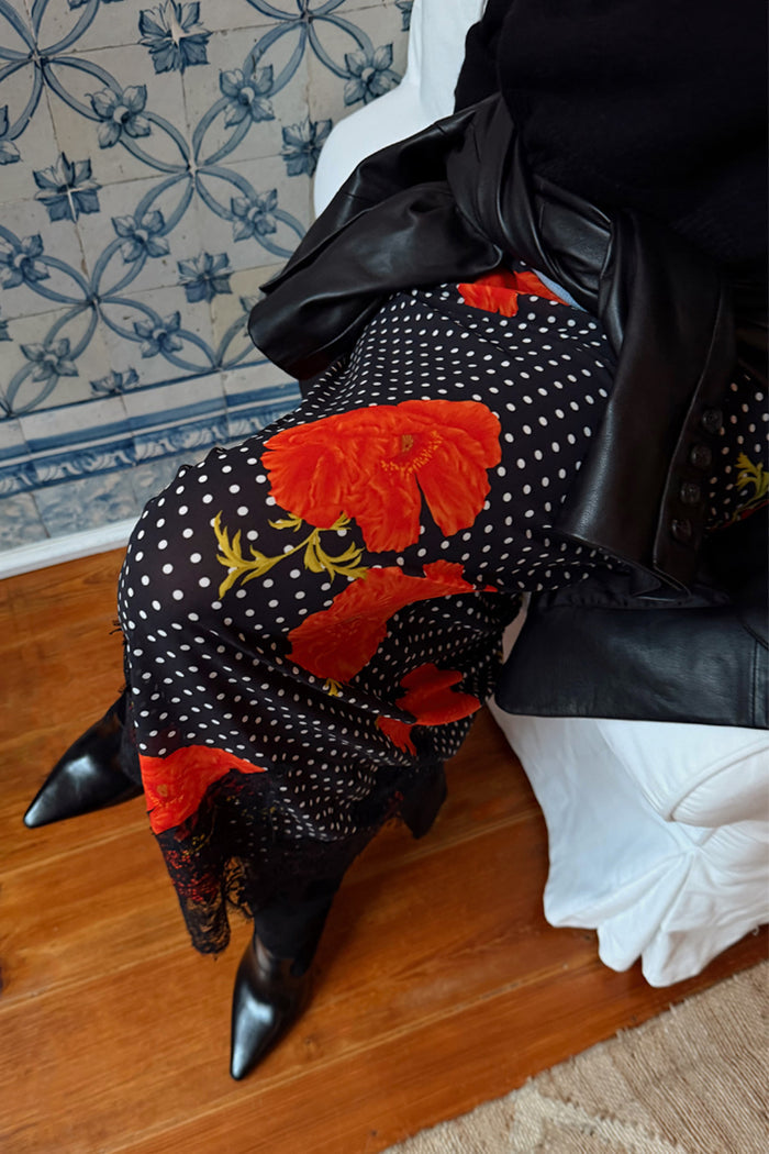 Black Poppy Midi Maeva Skirt in an iconic poppy and polka dot print with black lace trim, styled with boots.