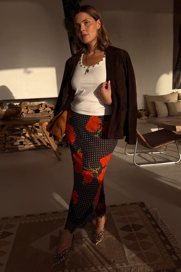 Black Poppy Midi Maeva Skirt with red poppy print and lace border, showcasing inclusive sizing for everyBODY.