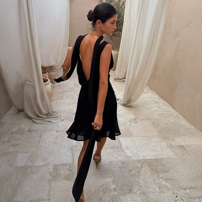 Black Sophie Mini Dress with a draped back and multi-wear scarf, designed in London with a fluid bias-cut.