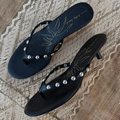 Black Stud Sandal Mule in leather with silver studs and a signature gold sun motif on the cushioned sole.