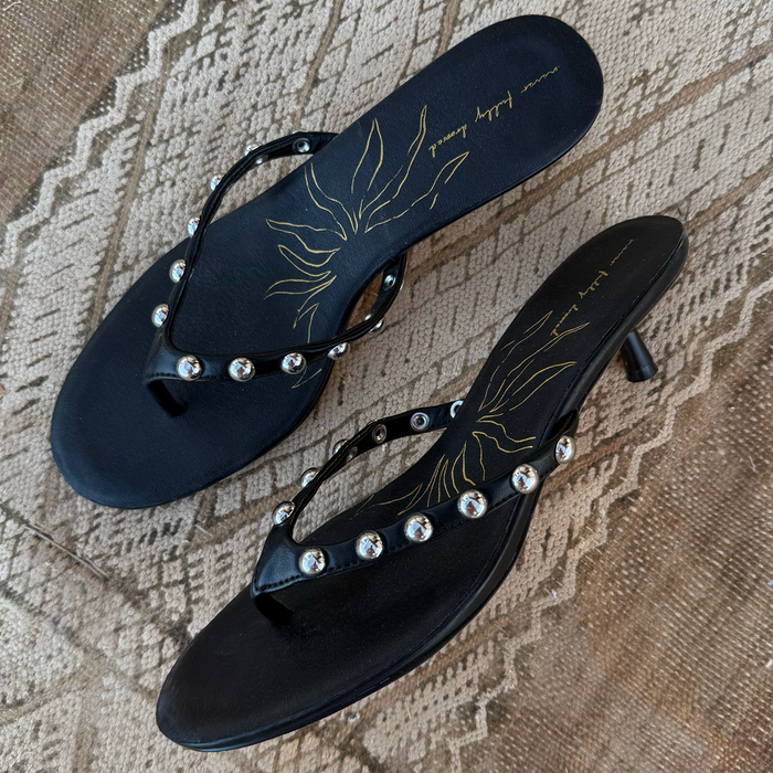 Black Stud Sandal Mule in leather with silver studs and a signature gold sun motif on the cushioned sole.