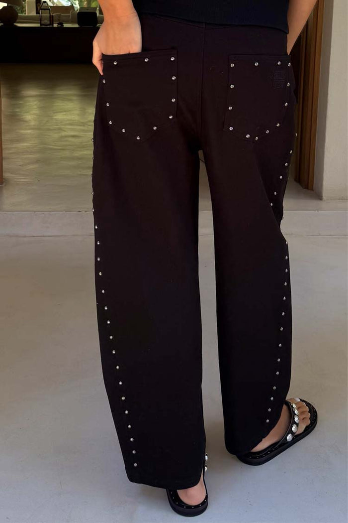 Black Studded Barrel Jeans featuring silver stud detailing on the back pockets and seams with a barrel leg silhouette.