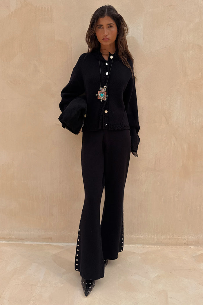 Black Studded Knit Trousers with silver side studs, styled as a monochromatic co-ord with a matching cardigan.