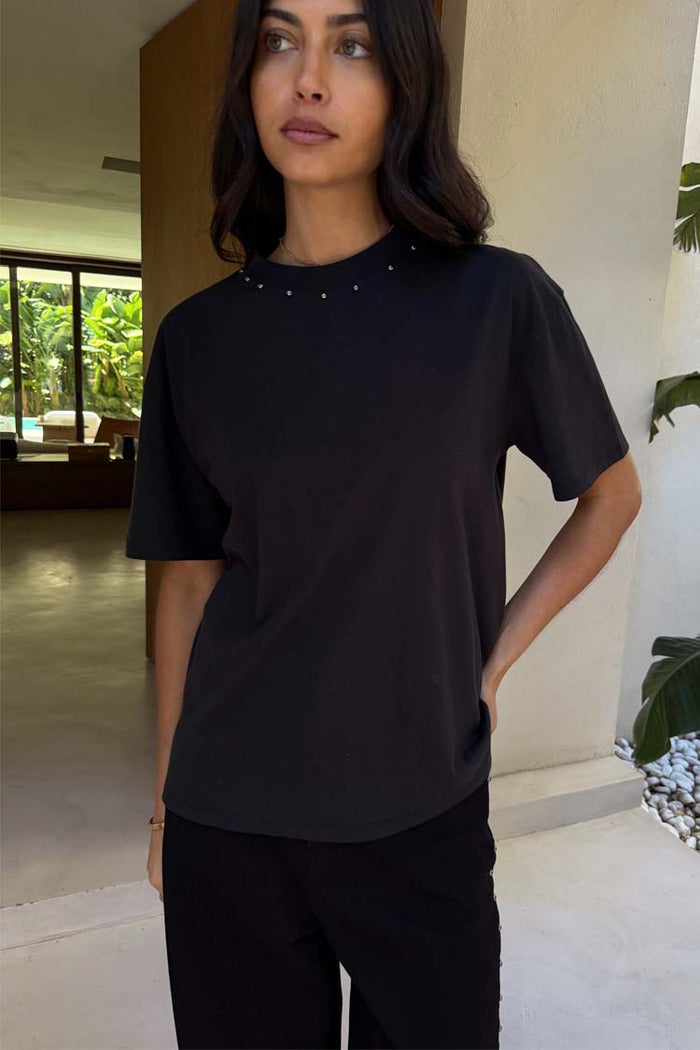 Black cotton T-shirt featuring a relaxed fit and silver stud detailing around the neckline.