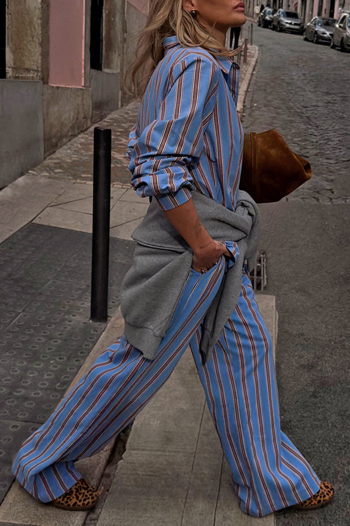 Blue Cotton Stripe Jogger with red pinstripes, styled with a matching shirt and grey sweater tied at the waist.