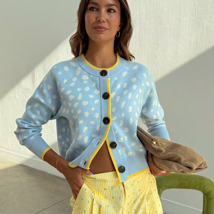 Blue Fawn Cheryl Cardigan in soft-touch blue knit with blush deer spots and yellow contrast trim.