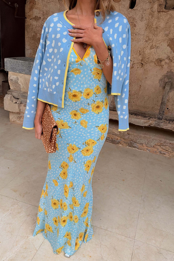 Blue Fawn Cheryl Cardigan with a pale blue spotted deer print and yellow trim, layered over a floral midi dress.