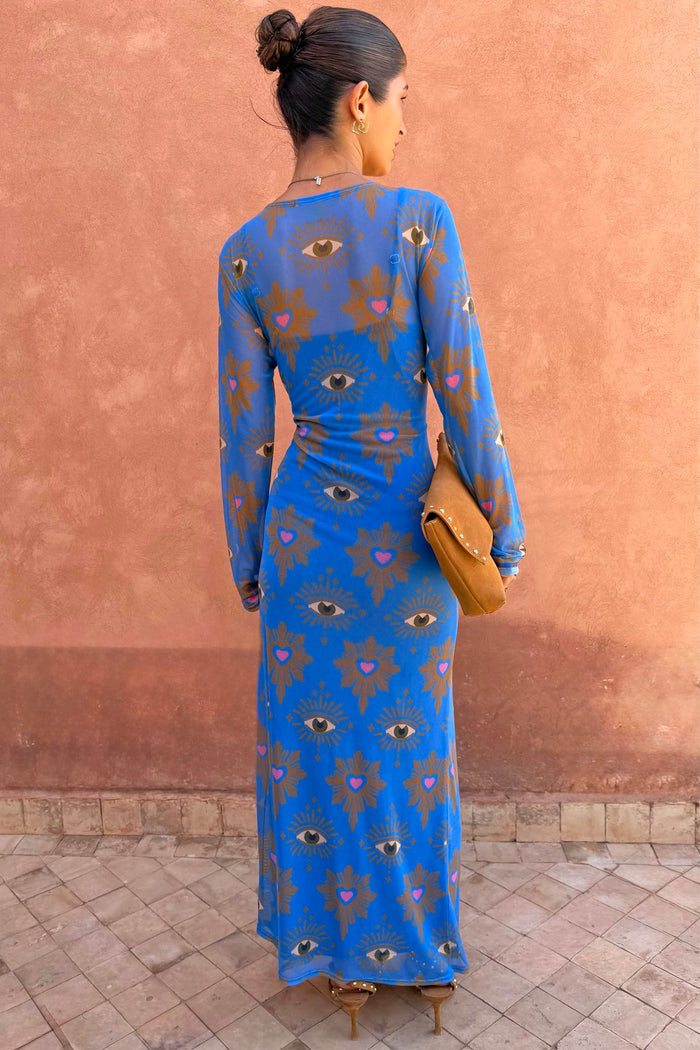Blue Eye Mesh Maxi Dress with heart and eye motifs and long sleeves, shown from the back on a model.