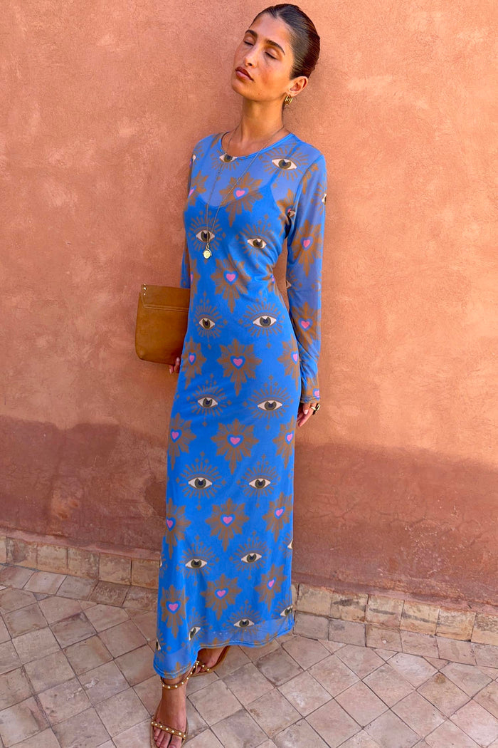 Blue Eye Mesh Dress with eye and heart motifs, long sleeves and a fitted maxi silhouette, styled on a model.