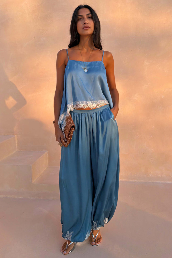 Blue Lace Balloon Trousers in washed blue satin with delicate lace trims and a fluid wide-leg silhouette.