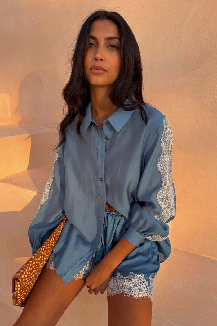 Blue Lace Marley Shirt with lace sleeve inserts, styled with matching lace-trim shorts and a leopard clutch.