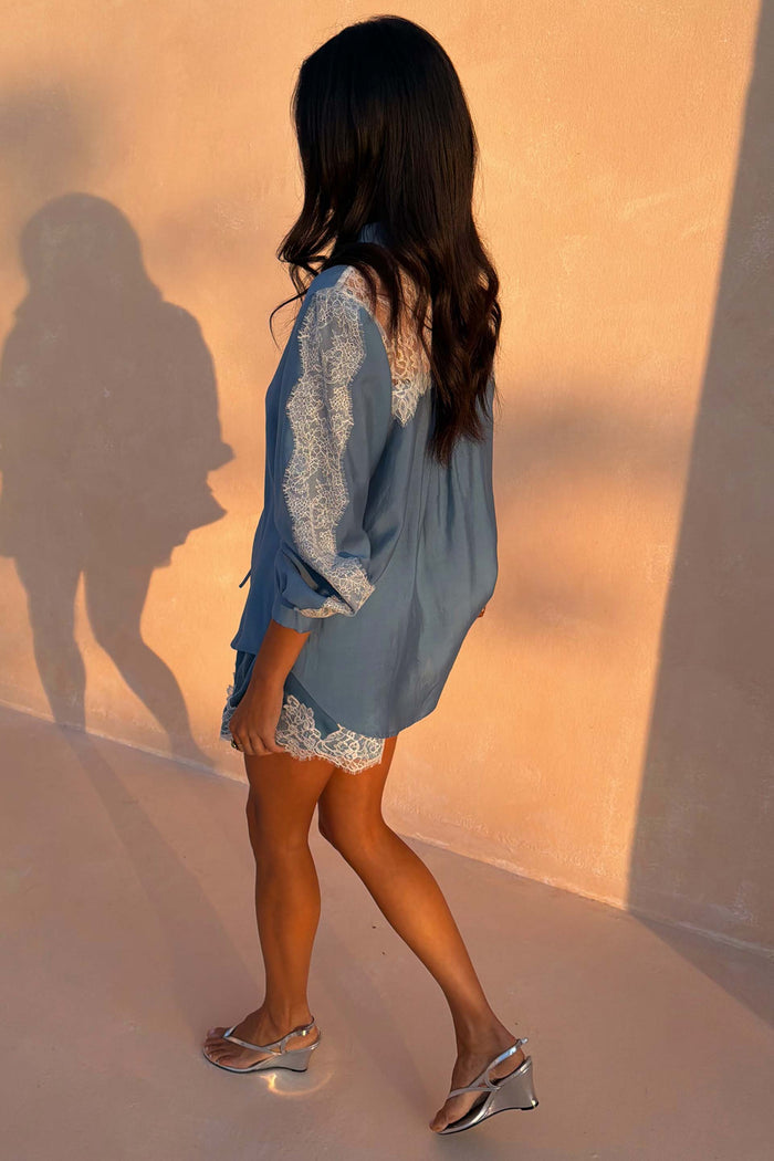 Blue Lace Marley Shirt with white lace panels on the sleeves and back, styled with matching shorts in warm sunlight.