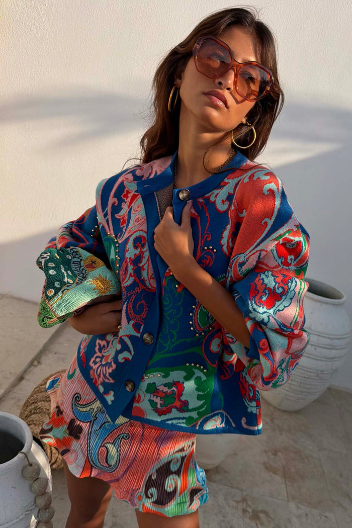 Blue Mari Cardigan featuring a deep blue paisley print with orange and turquoise tones and a button-up front.