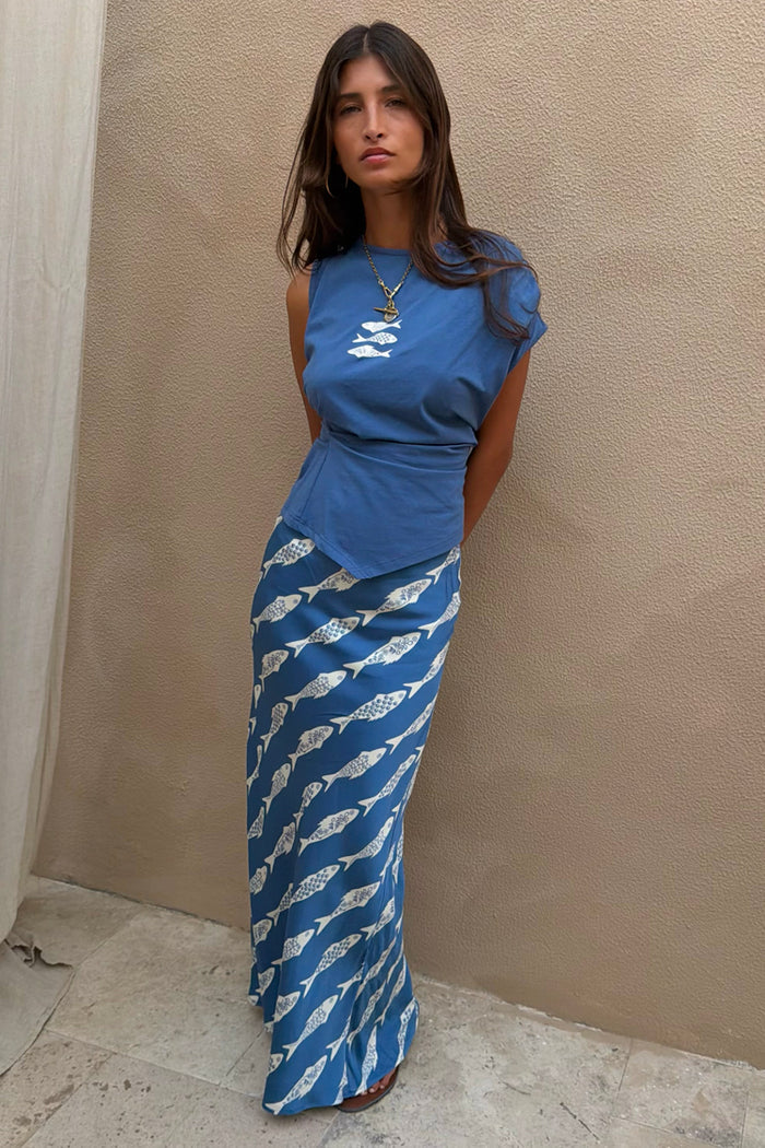 Blue Marina A-Symmetric Top with fish motifs and a cinched waist, styled as a co-ord with the matching skirt.