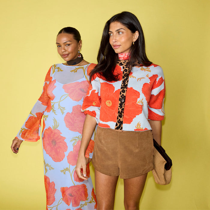 Blue Poppy Cardigan in pale blue with orange poppy print and leopard trim, shown on two models for inclusive sizing.