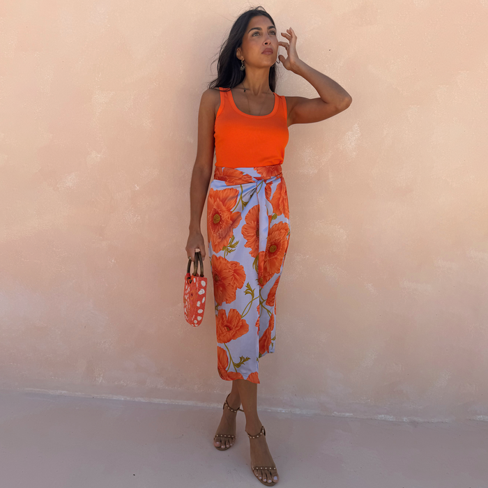 Blue Poppy Jaspre Skirt with an orange floral print and wrap tie, designed in London for multi-wear dopamine dressing.
