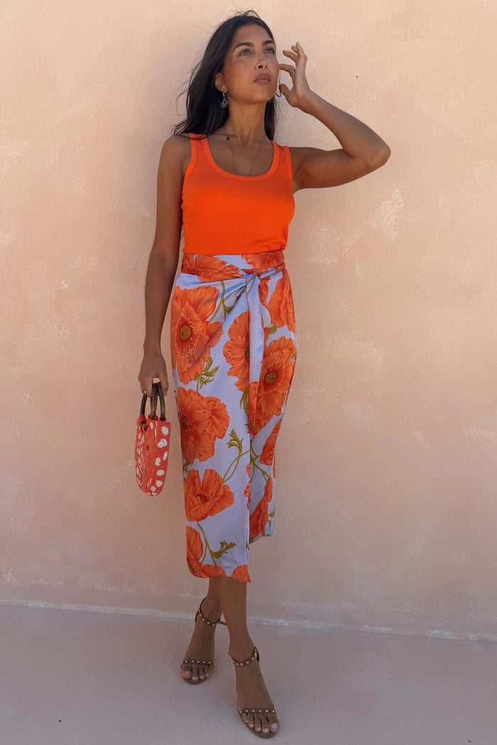 Iconic Blue Poppy Jaspre Skirt with an orange poppy print and wrap tie fastening on a model.