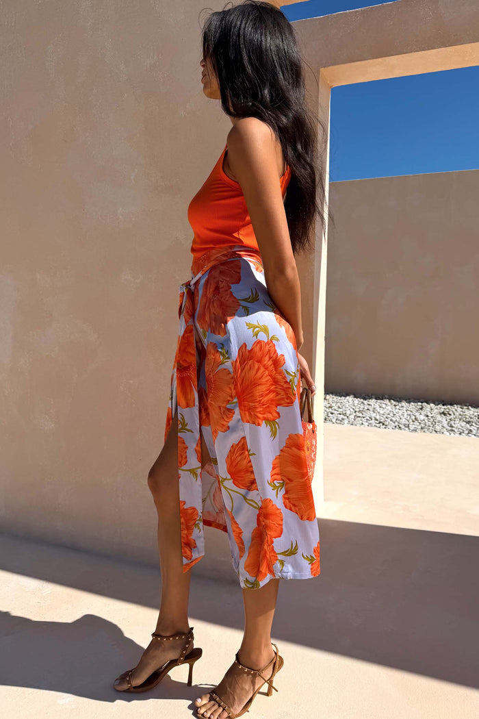 Iconic Blue Poppy Jaspre Skirt featuring an orange poppy print and adjustable multi-wear wrap tie.